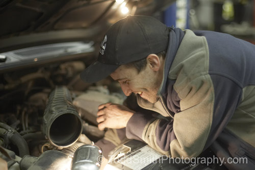 Tony works under the hood at Oliver Brake and Muffler